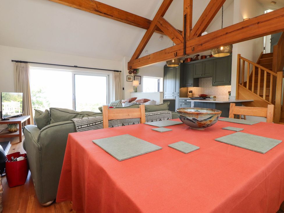 A living room with a dining table and sofa at Hafod in Nefyn