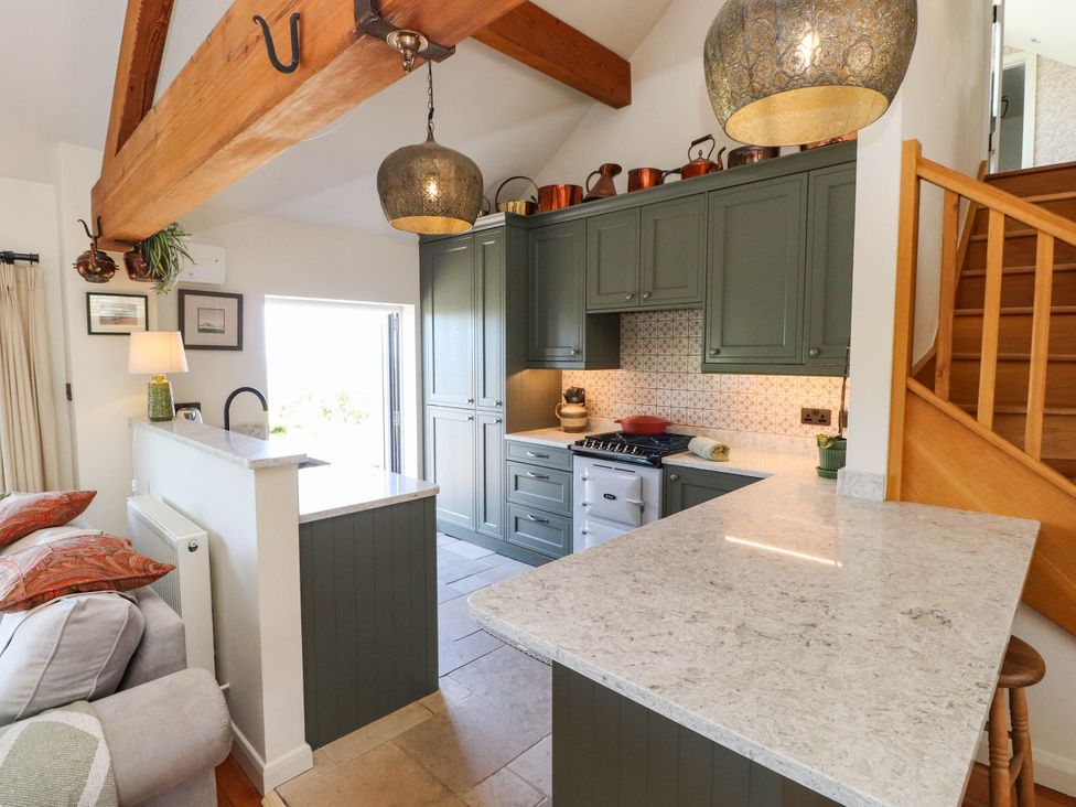 A kitchen with cabinets and a stove at Hafod in Nefyn