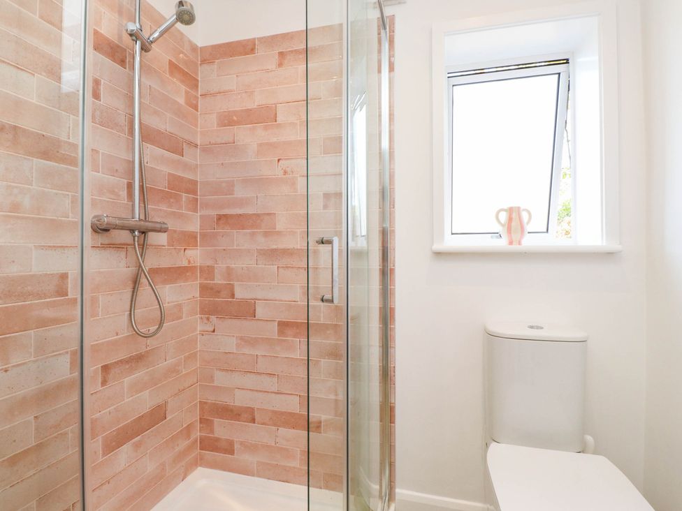 A bathroom with a shower and toilet at Hafod in Nefyn