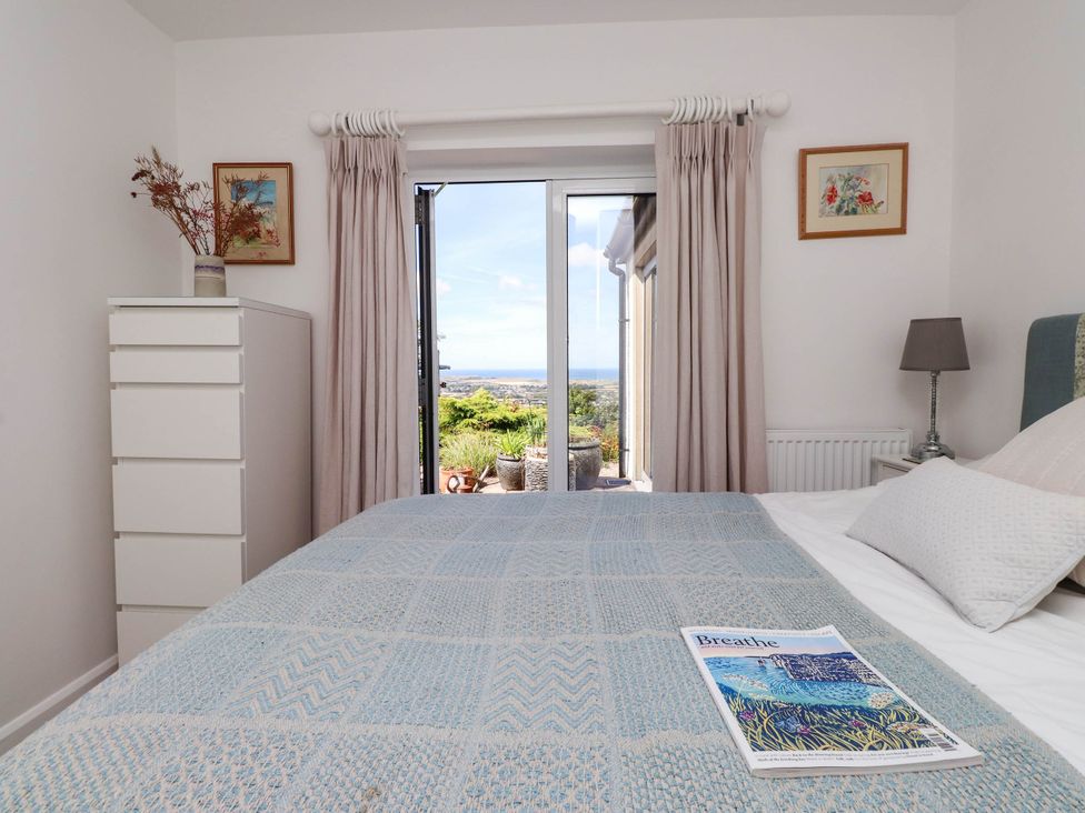 A bedroom with a bed and chest of drawers at Hafod in Nefyn
