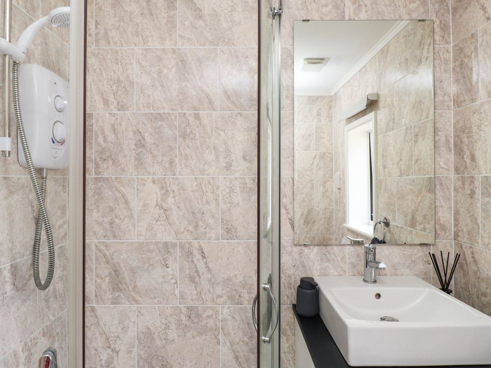 A bathroom with a sink and shower at Hafod in Nefyn