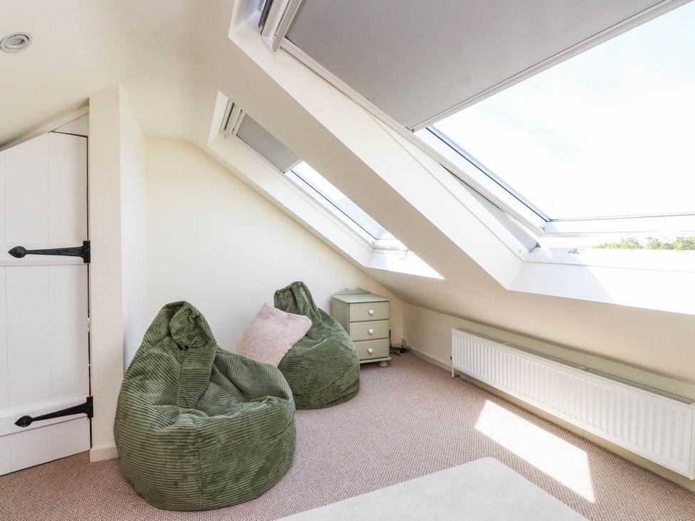 An attic with bean bags and a chest of drawers at Hafod in Nefyn