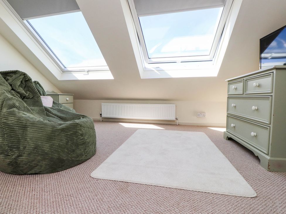 A loft with a bean bag and dresser at Hafod in Nefyn