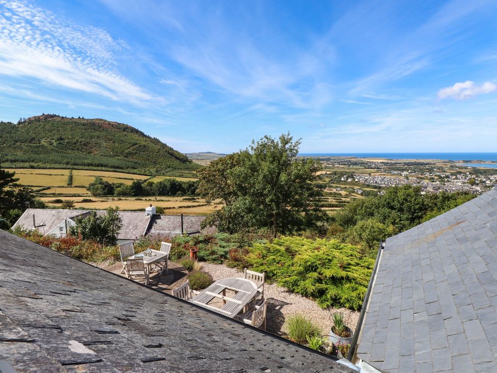 A garden with a view of a mountain and sea at Hafod in Nefyn