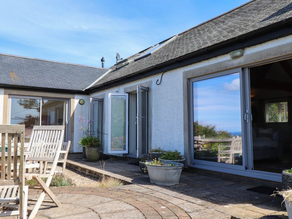 An outdoor area with a door and windows at Hafod in Nefyn