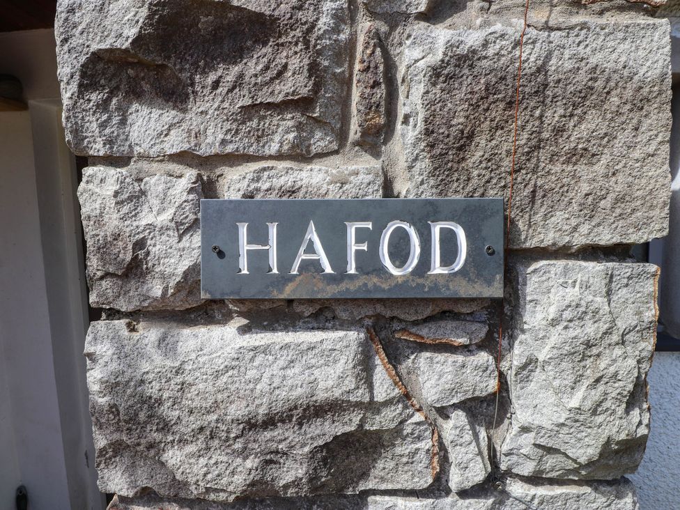 A sign displaying Hafod on a stone wall at Hafod in Nefyn