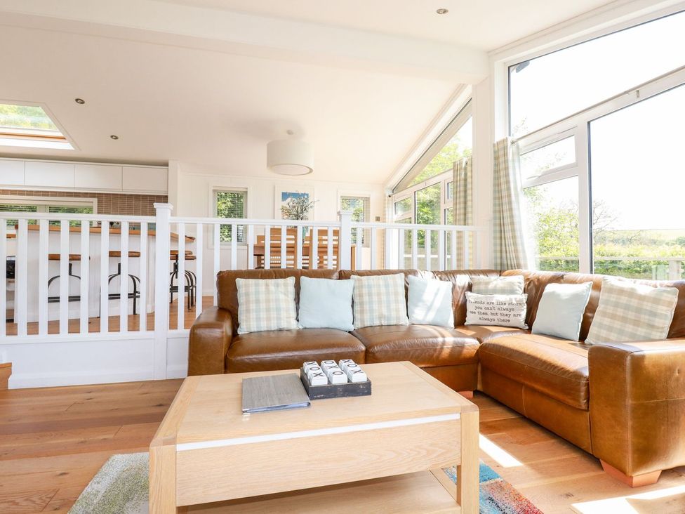 A living room with a sofa and coffee table at 4 Tree Tops in Liskeard