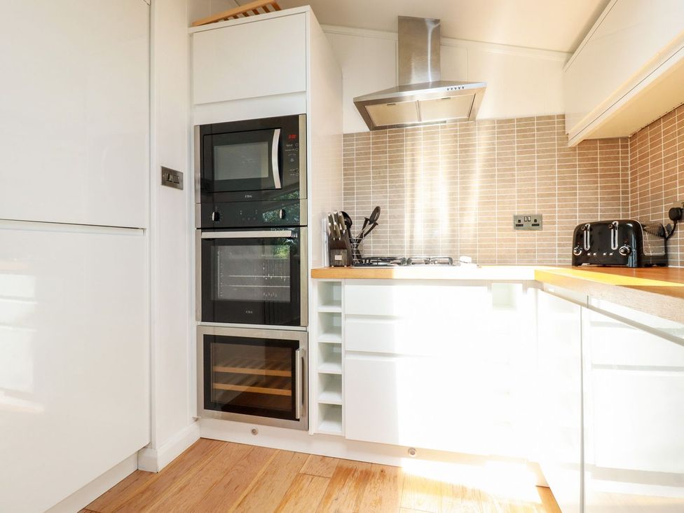 A kitchen with appliances and utensils at 4 Tree Tops in Liskeard