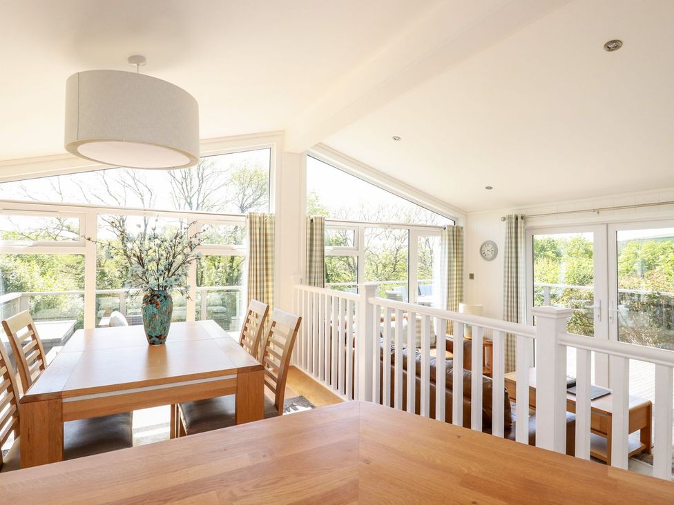 A dining room with a table and chairs at 4 Tree Tops in Liskeard