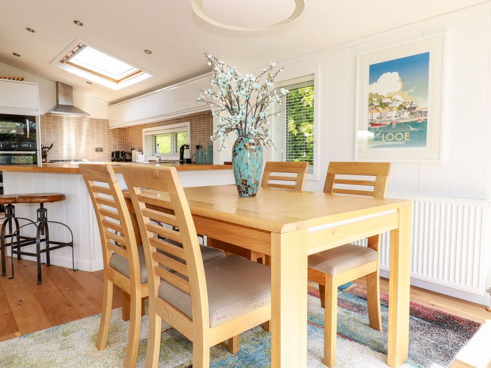 A dining room with a table and chairs at 4 Tree Tops in Liskeard