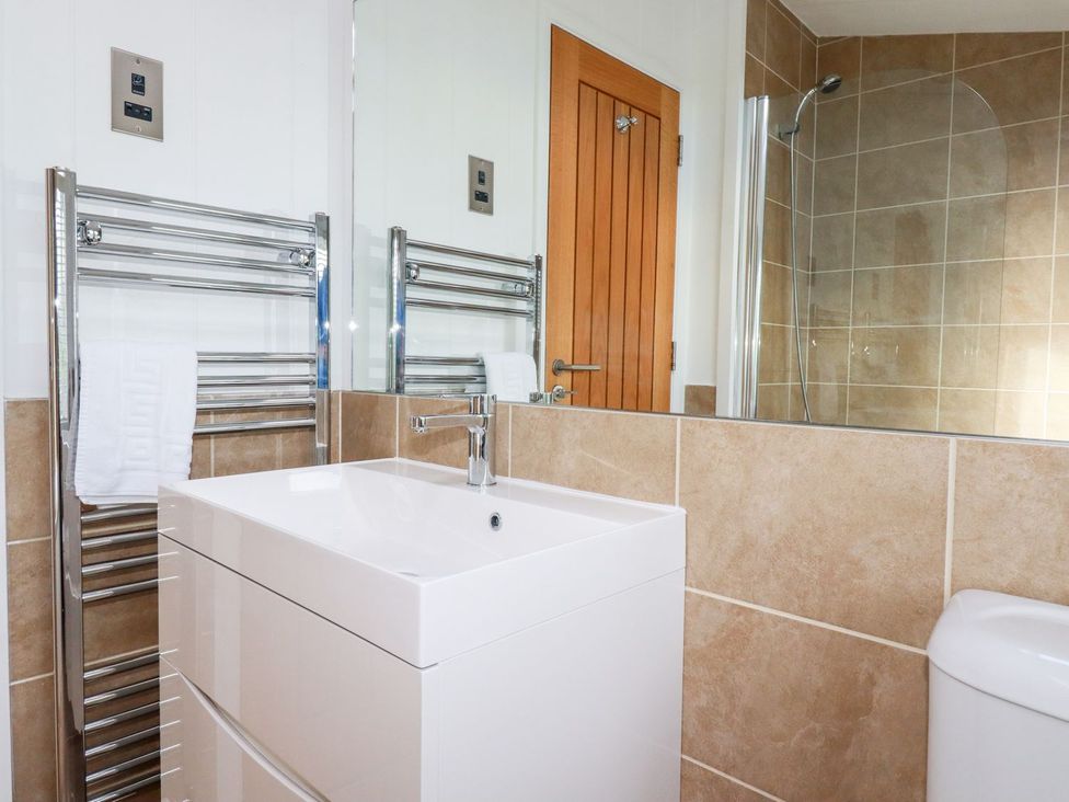 A bathroom featuring a sink and towel radiator at 4 Tree Tops in Liskeard