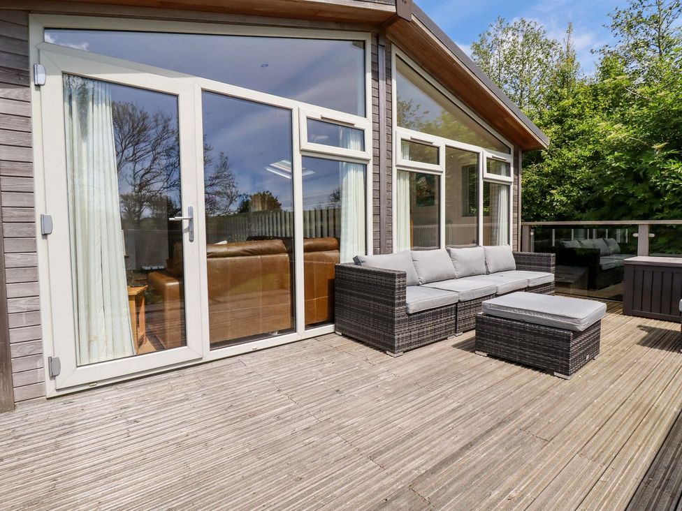 An outdoor patio with a sofa and ottoman at 4 Tree Tops Liskeard