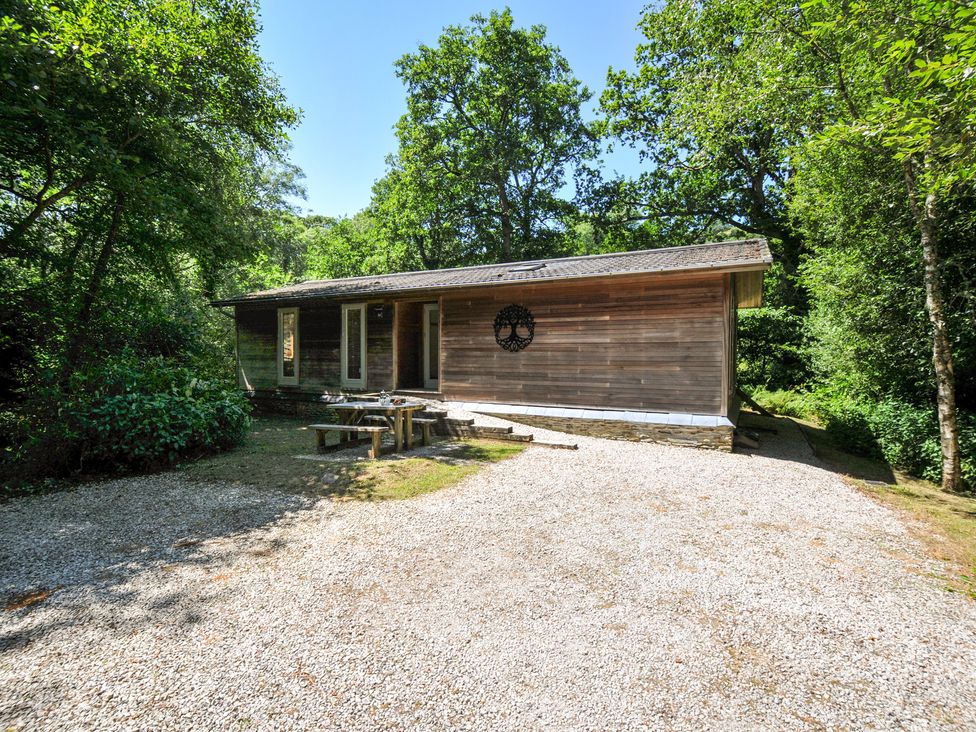 A house with outdoor furniture and a gravel driveway at 1 Stonerush Valley in Liskeard