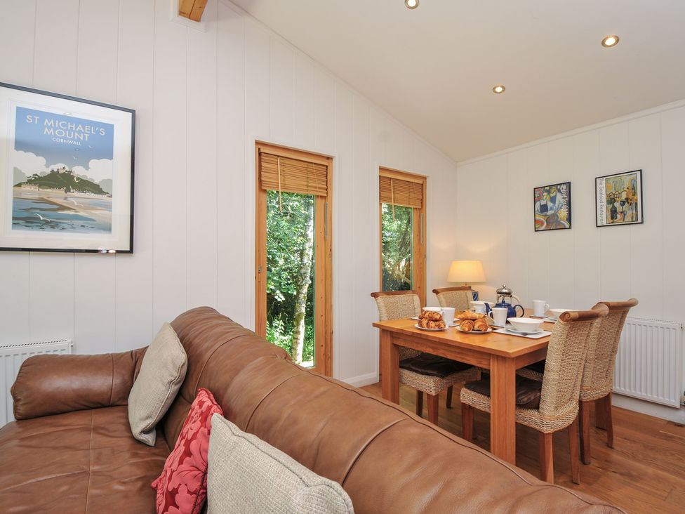 A dining area with a wooden table and chairs at 1 Stonerush Valley Liskeard