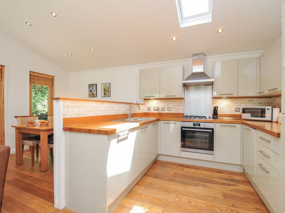 A kitchen with a sink and stove at 1 Stonerush Valley in Liskeard