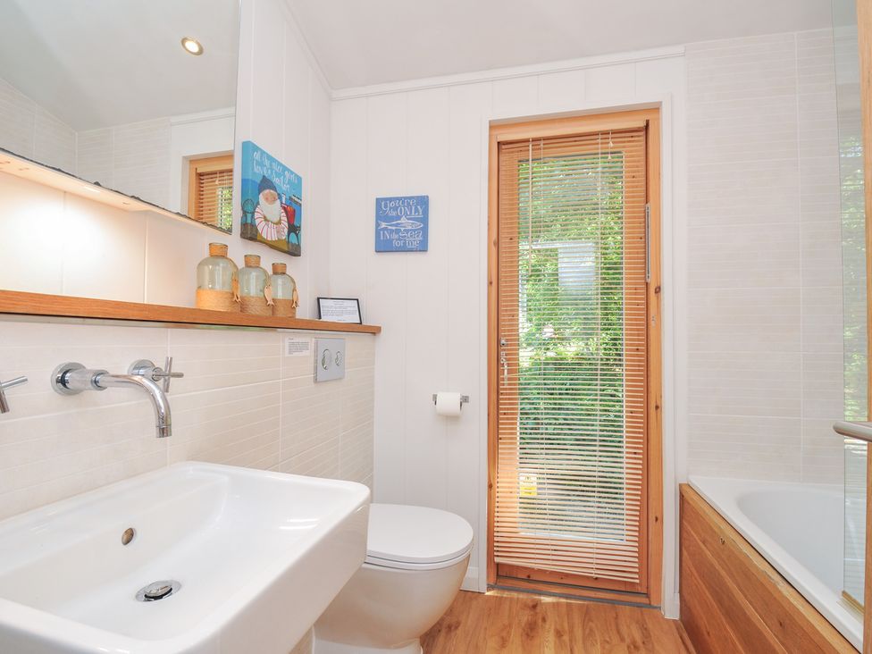 A bathroom with a sink, toilet, and bathtub at 1 Stonerush Valley in Liskeard