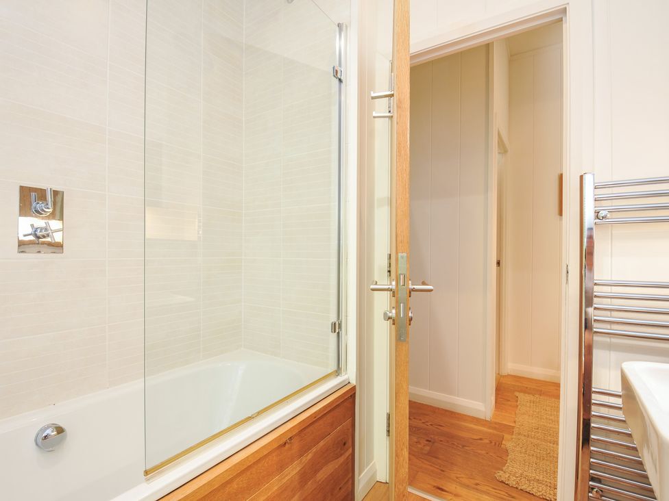 A bathroom with a bathtub and shower at 1 Stonerush Valley in Liskeard