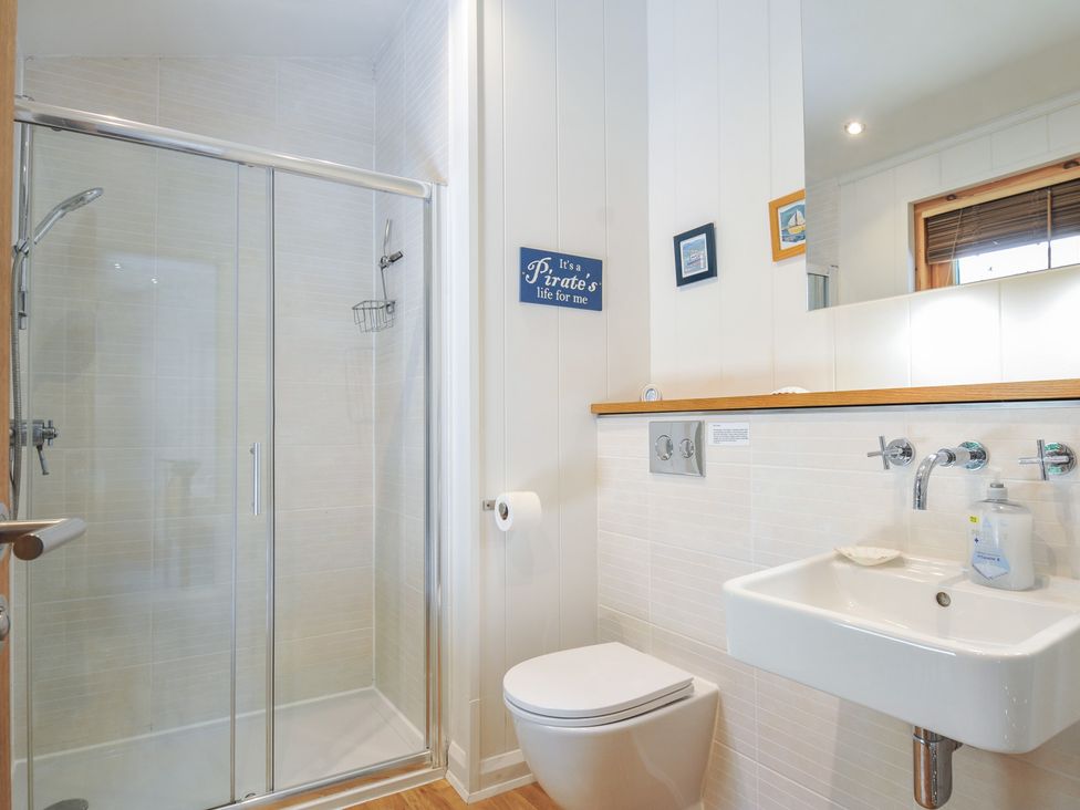 A bathroom with a shower, toilet, and sink at 1 Stonerush Valley in Liskeard