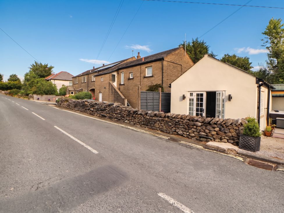 A house with a stone wall on a road at Fourways