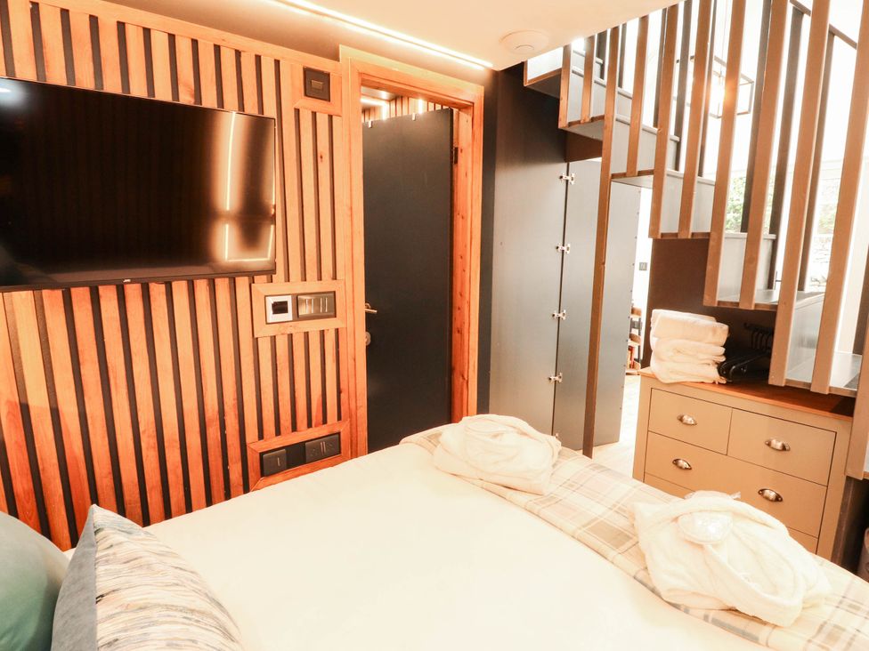 A bedroom with a bed and television at Fourways