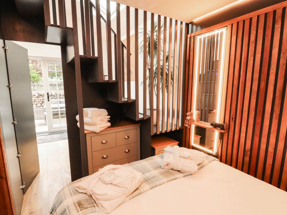 A bedroom with a bed and stairs at Fourways