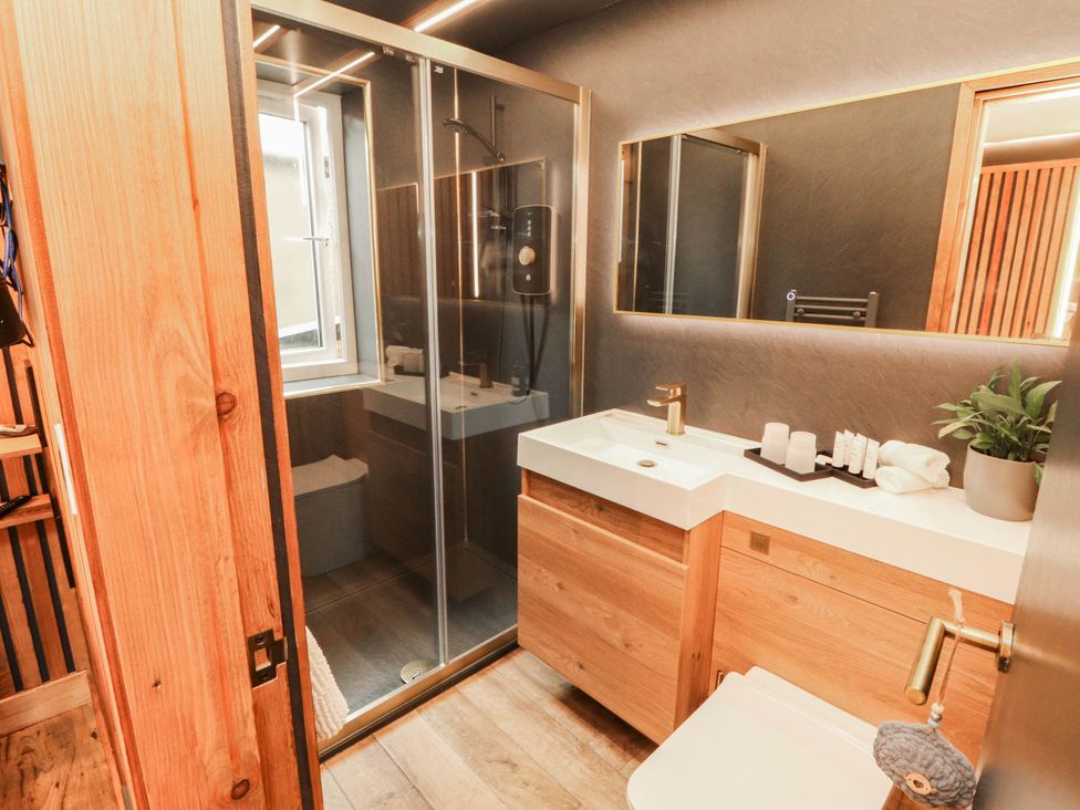 A bathroom with a shower, sink, and toilet at Fourways