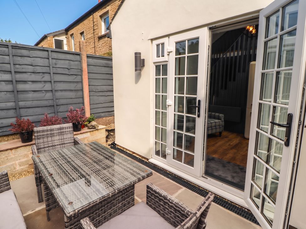 An outdoor seating area with a table and chairs at Fourways