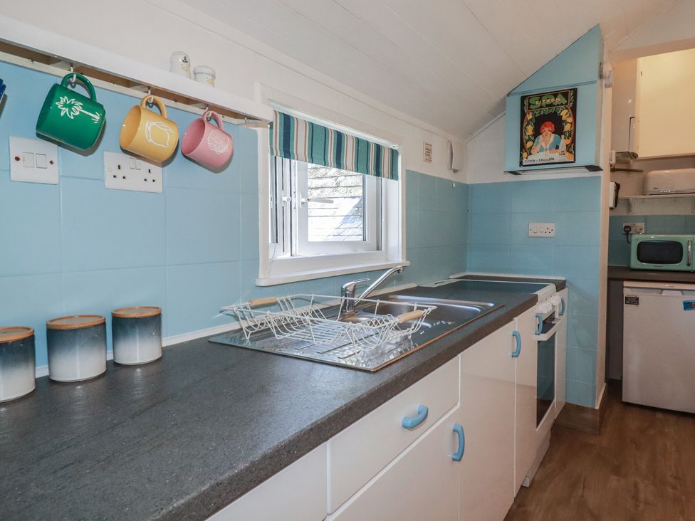 A kitchen with a sink and cooking range at Harbourside Retreat in Looe