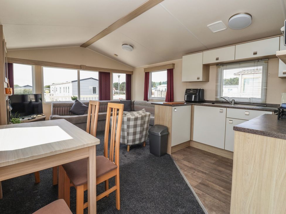 A living room with a sofa and dining table at Paws and Relax in 