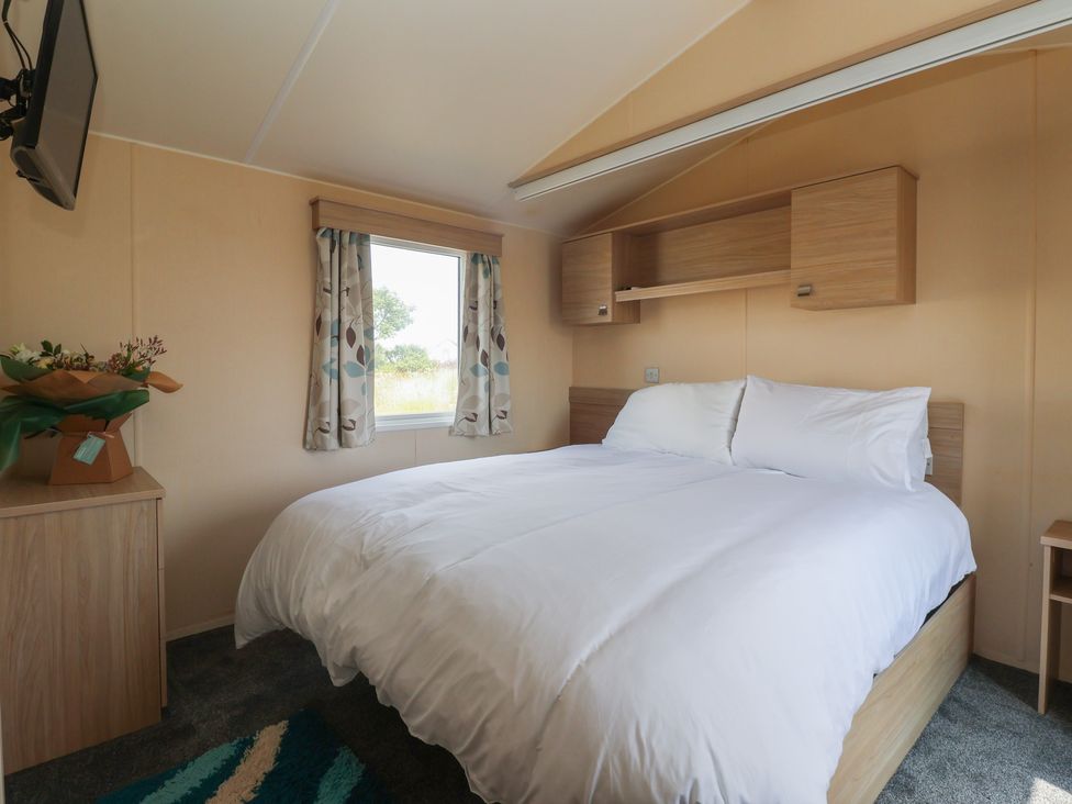 A bedroom with a bed and a television at Paws and Relax