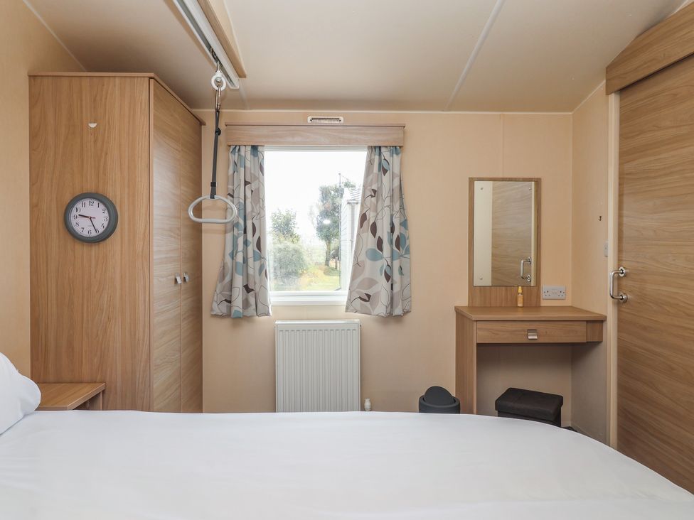 A bedroom with a bed and desk at Paws and Relax 