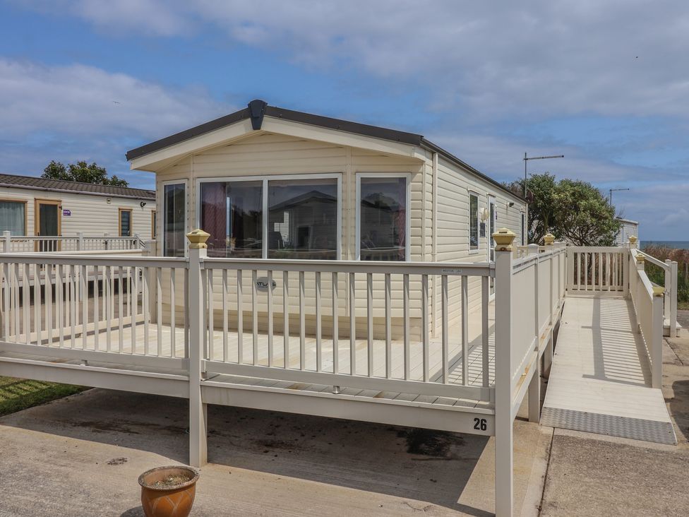 A mobile home with a deck and pathway at Paws and Relax in 
