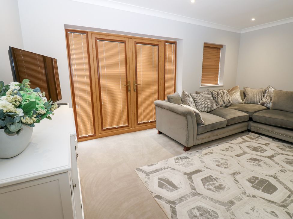 A living room with a corner sofa and television at Black Banks Farm Cottage Darlington