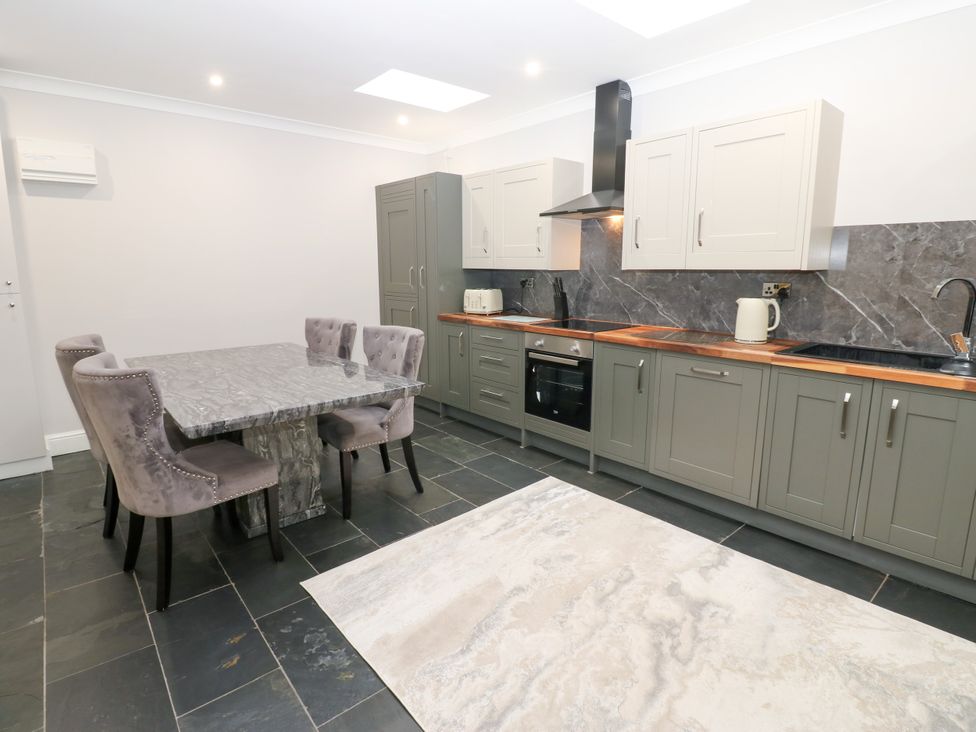 A kitchen with a table and chairs at Black Banks Farm Cottage, Darlington