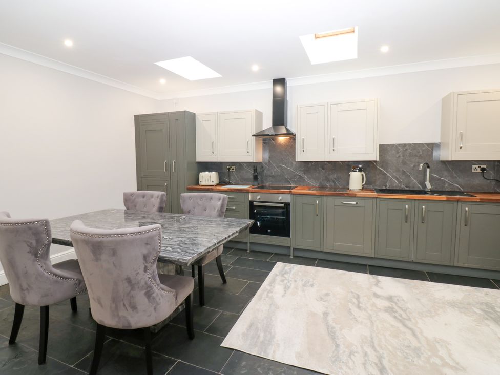 A kitchen with dining table and chairs at Black Banks Farm Cottage in Darlington