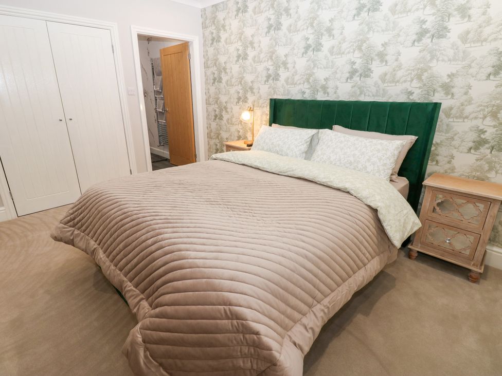 A bedroom with a bed and bedside table at Black Banks Farm Cottage in Darlington