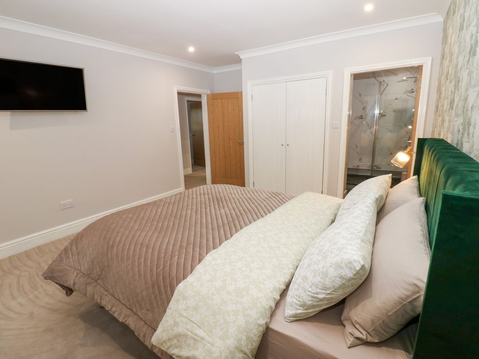 A bedroom with a bed and television at Black Banks Farm Cottage in Darlington