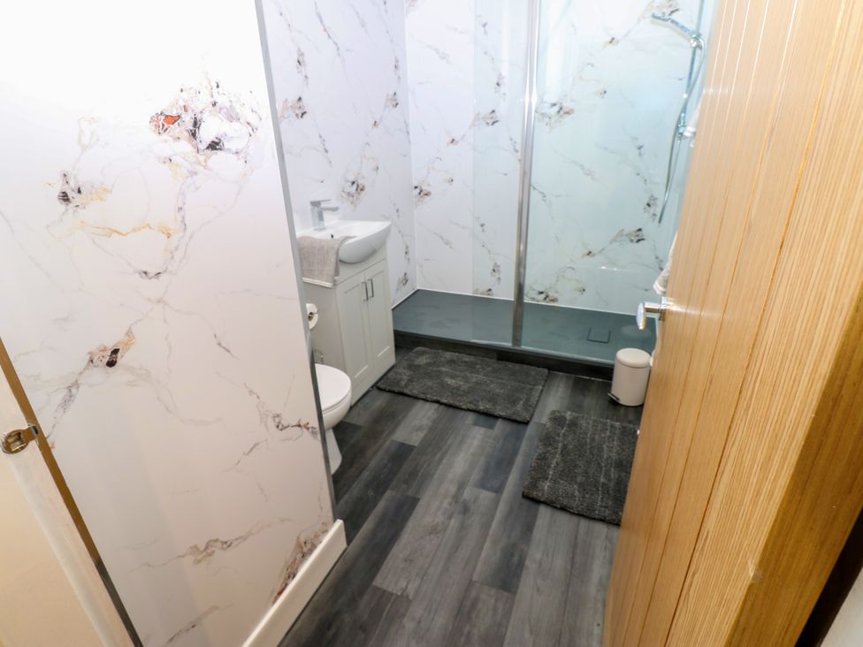 A bathroom with a shower, toilet, and sink at Black Banks Farm Cottage in Darlington