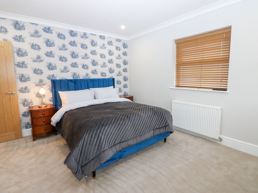 A bedroom with a bed and bedside table at Black Banks Farm Cottage in Darlington