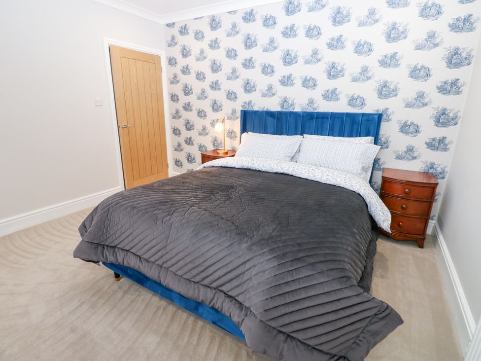 A bedroom with a bed and bedside table at Black Banks Farm Cottage in Darlington