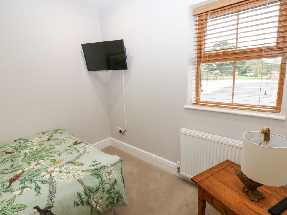 A bedroom with a bed and television at Black Banks Farm Cottage Darlington