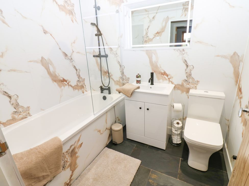 A bathroom with a bathtub, sink, and toilet at Black Banks Farm Cottage in Darlington