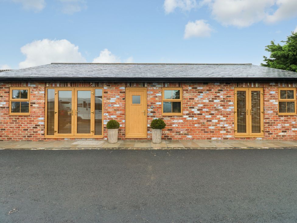 A brick building with windows and a door at Black Banks Farm Cottage Darlington