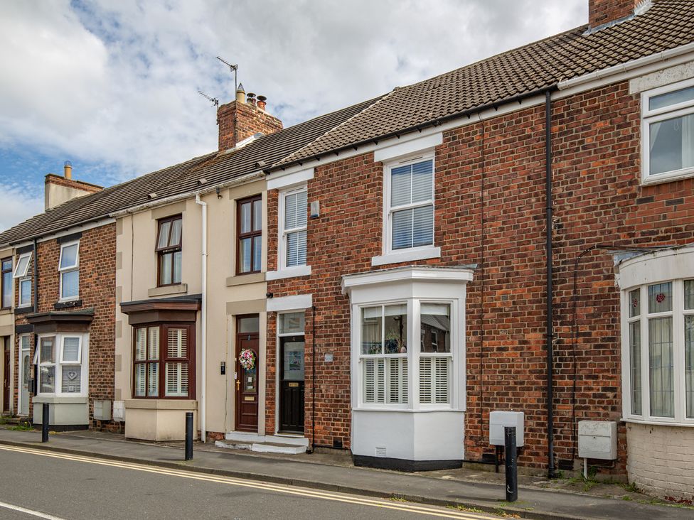 A row of houses with brick walls and windows at Hudson House 