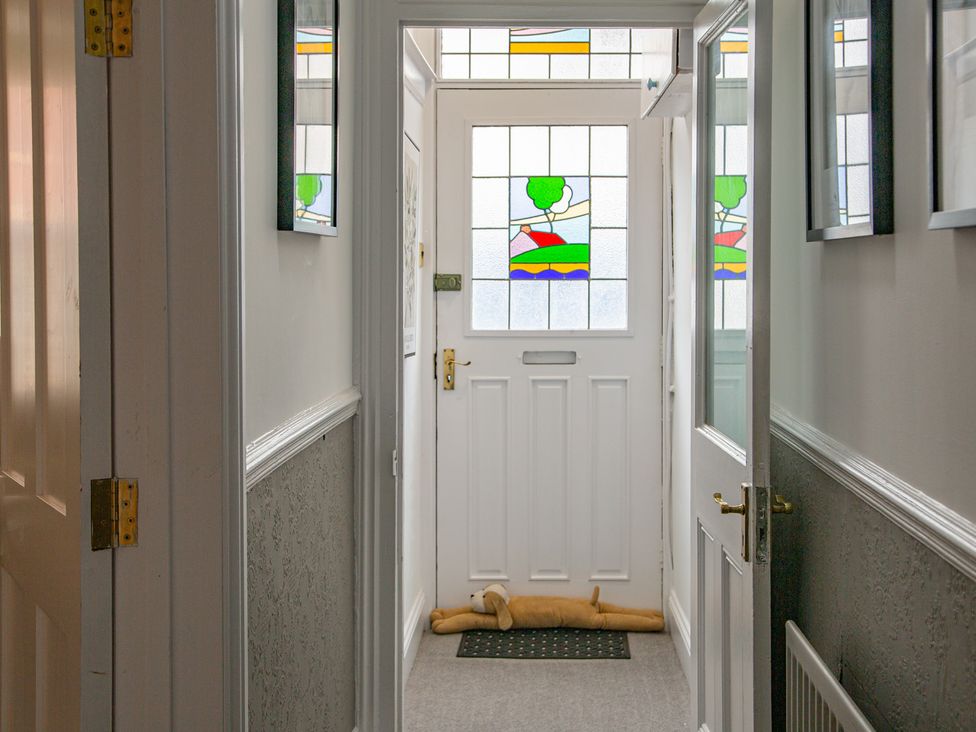 A hallway with a front door and stained glass window at Hudson House 