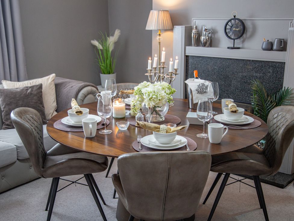 A dining table set with tableware and flowers at Hudson House