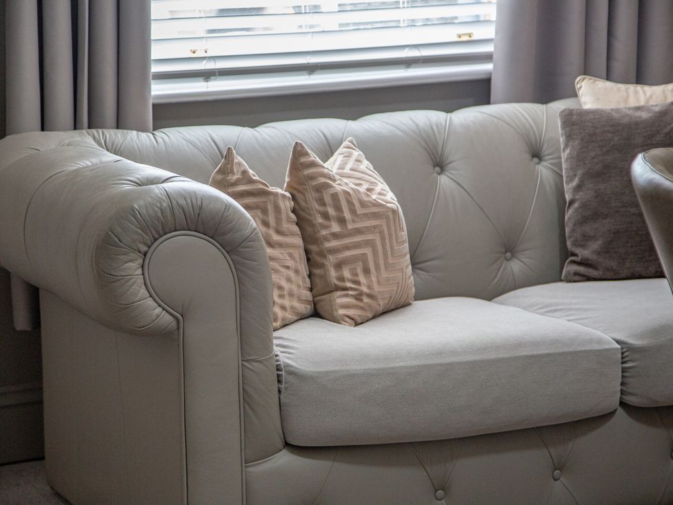 A sofa with cushions in a living room at Hudson House