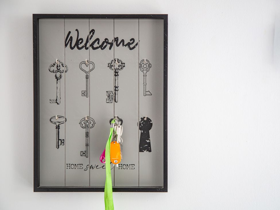 A key rack with keys and a welcome sign at Hudson House