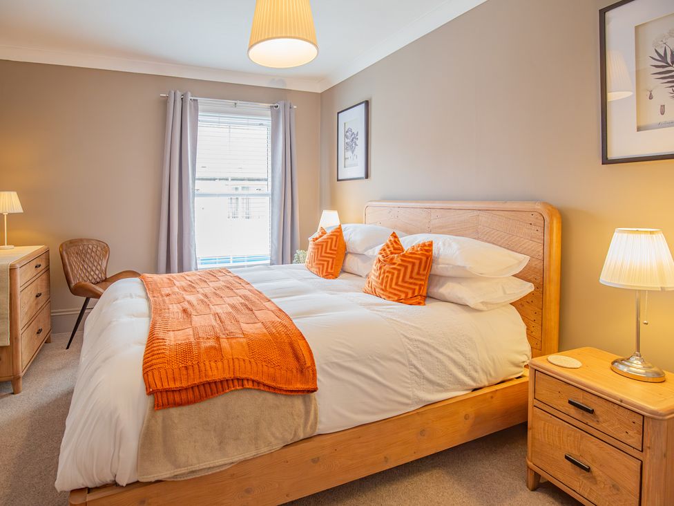 A bedroom with a bed and bedside table at Hudson House