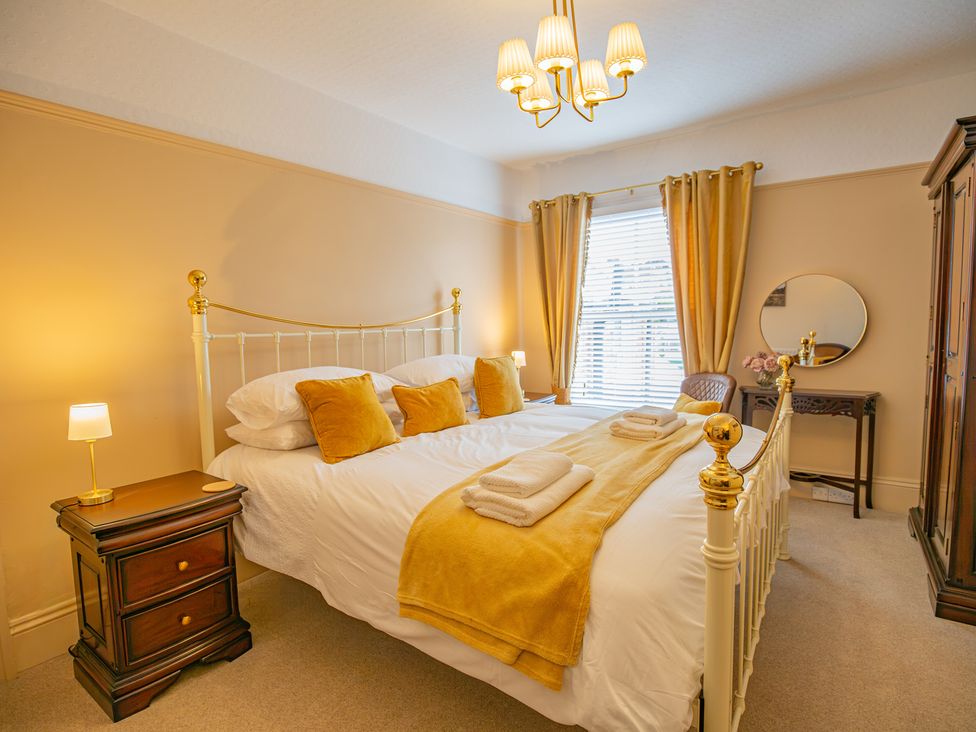 A bedroom with a bed and nightstand at Hudson House